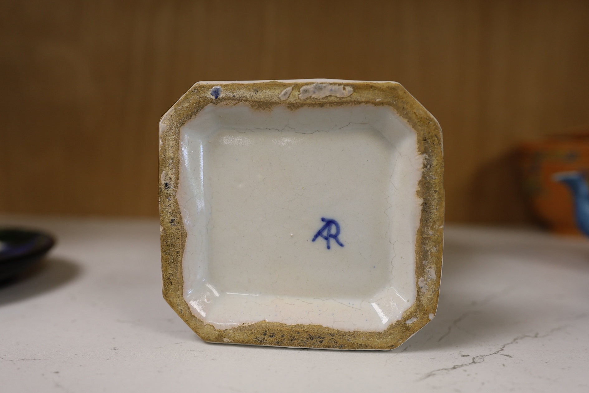 A 19th century Delft blue and white vase and a Watcombe Torquay pottery chamberstick, 19.5cm. Condition - both fair